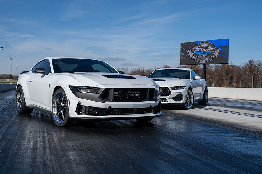 Two S650 Mustangs Pose for a Photo on a Drag Strip